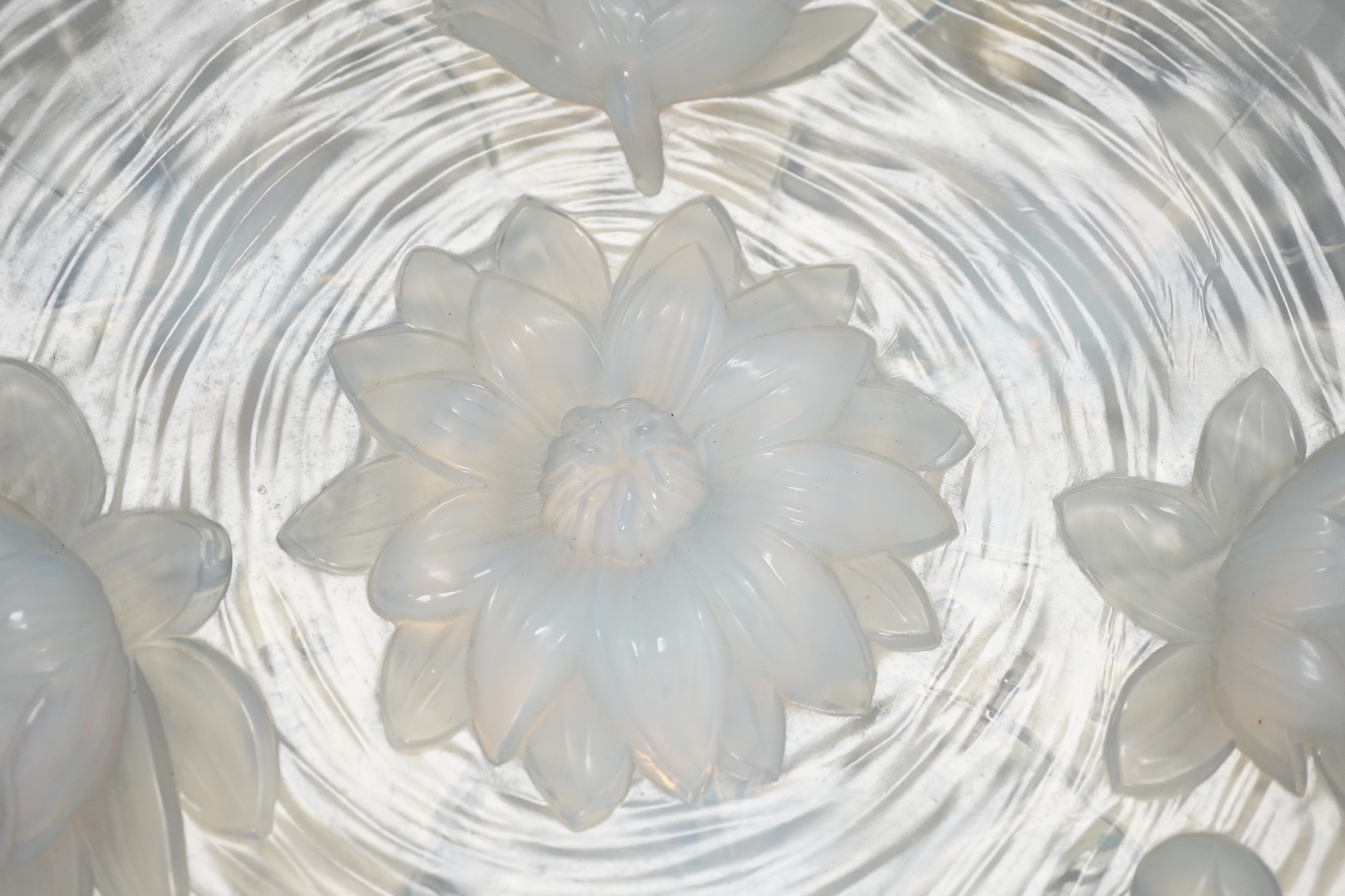 A Verlys opalescent glass dish with flower decoration. 35cm diameter